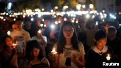 Thousands of people take part in a candlelight vigil to mark the 30th anniversary of the crackdown of pro-democracy movement at Beijing's Tiananmen Square in 1989, at Victoria Park in Hong Kong, China, June 4, 2019.