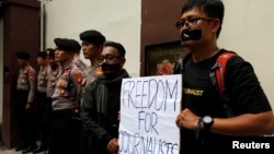FILE - Journalists take part in a protest against the recent imprisonment by Myanmar authorities of Reuters journalists Wa Lone, 32, and Kyaw Soe Oo, 28, outside the Myanmar embassy in Jakarta, Indonesia, Sept. 7, 2018. 