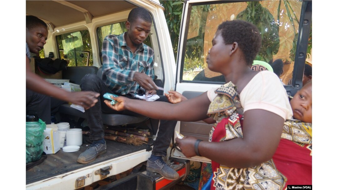 Flood survivors receive medication during mobile clinic hours in Machinga district.