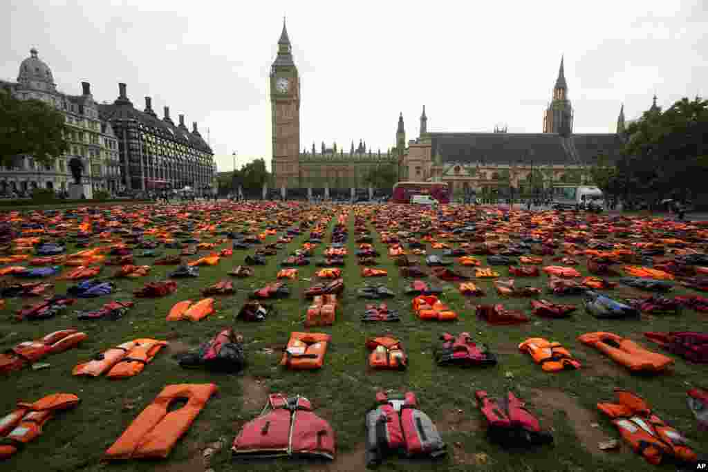 About 2,500 lifejackets worn by refugees, who made the sea crossing from Turkey to the Greek, island of Chios, are displayed in what the organizers called a "Lifejacket Graveyard" in Parliament Square, London, with the Houses of Parliament seen in the background.