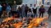 Opposition supporters stand in front of a fire during clashes with riot police at a rally against President Nicolas Maduro in Caracas, Venezuela, May 3, 2017.