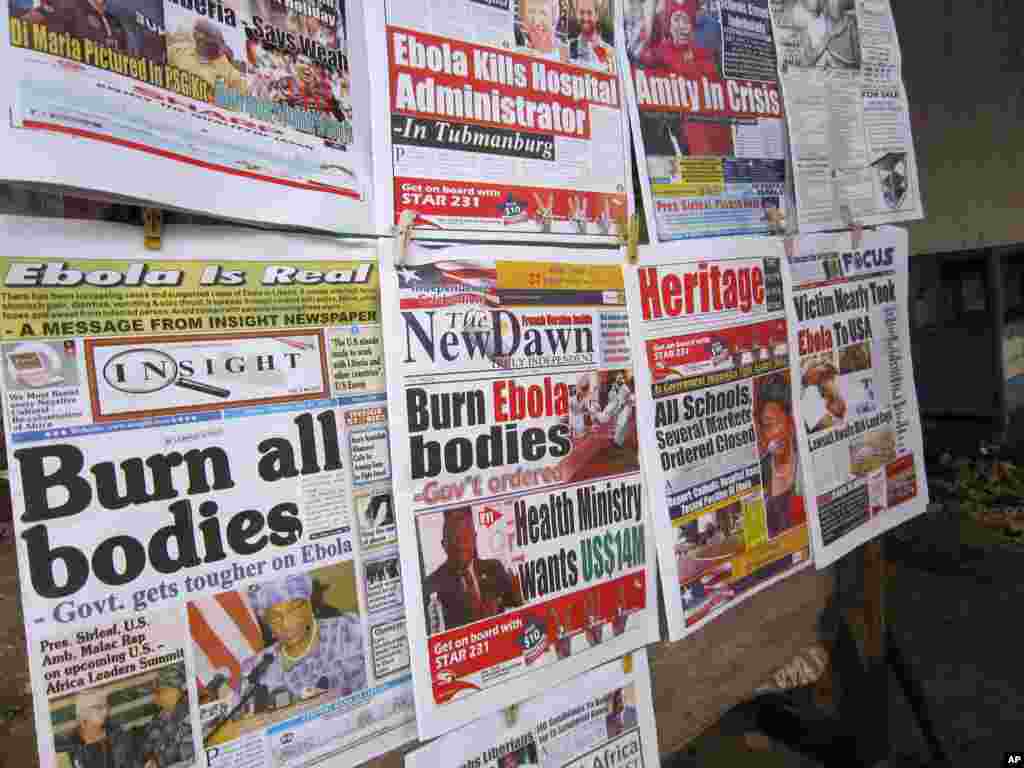 A close up of newspaper front pages focusing on the Ebola outbreak, including a newspaper (l) reading &#39;Burn all bodies&#39; in the city of Monrovia, Liberia.