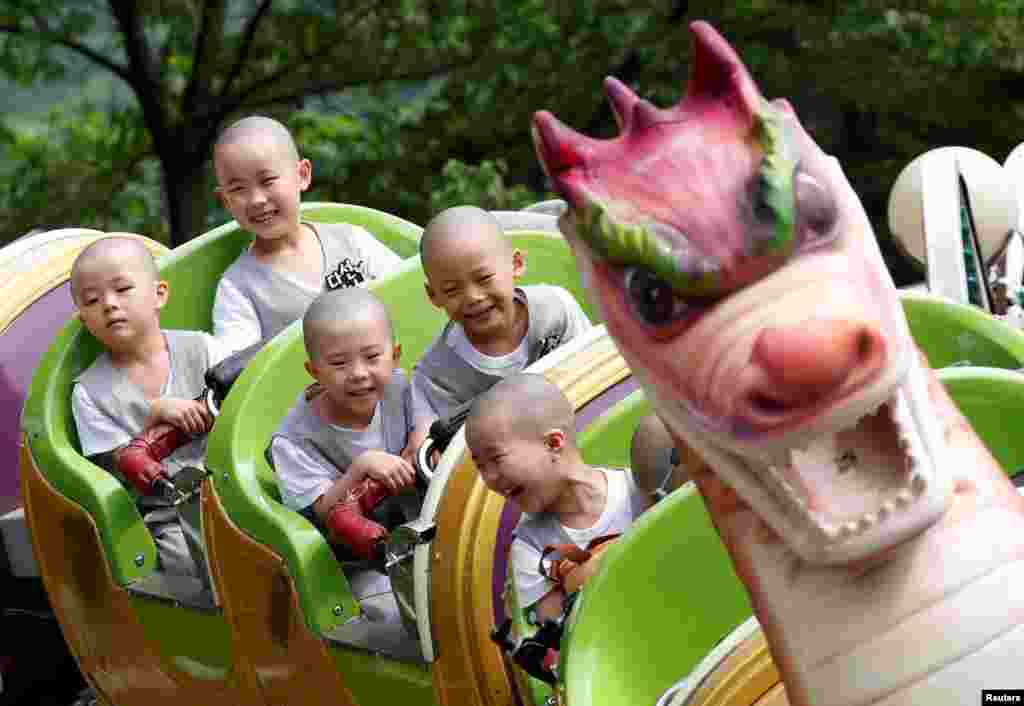 Para pendeta Budha anak-anak tampak gembira menikmati hiburan di taman bermain Everland, Yongin, Korea Selatan.