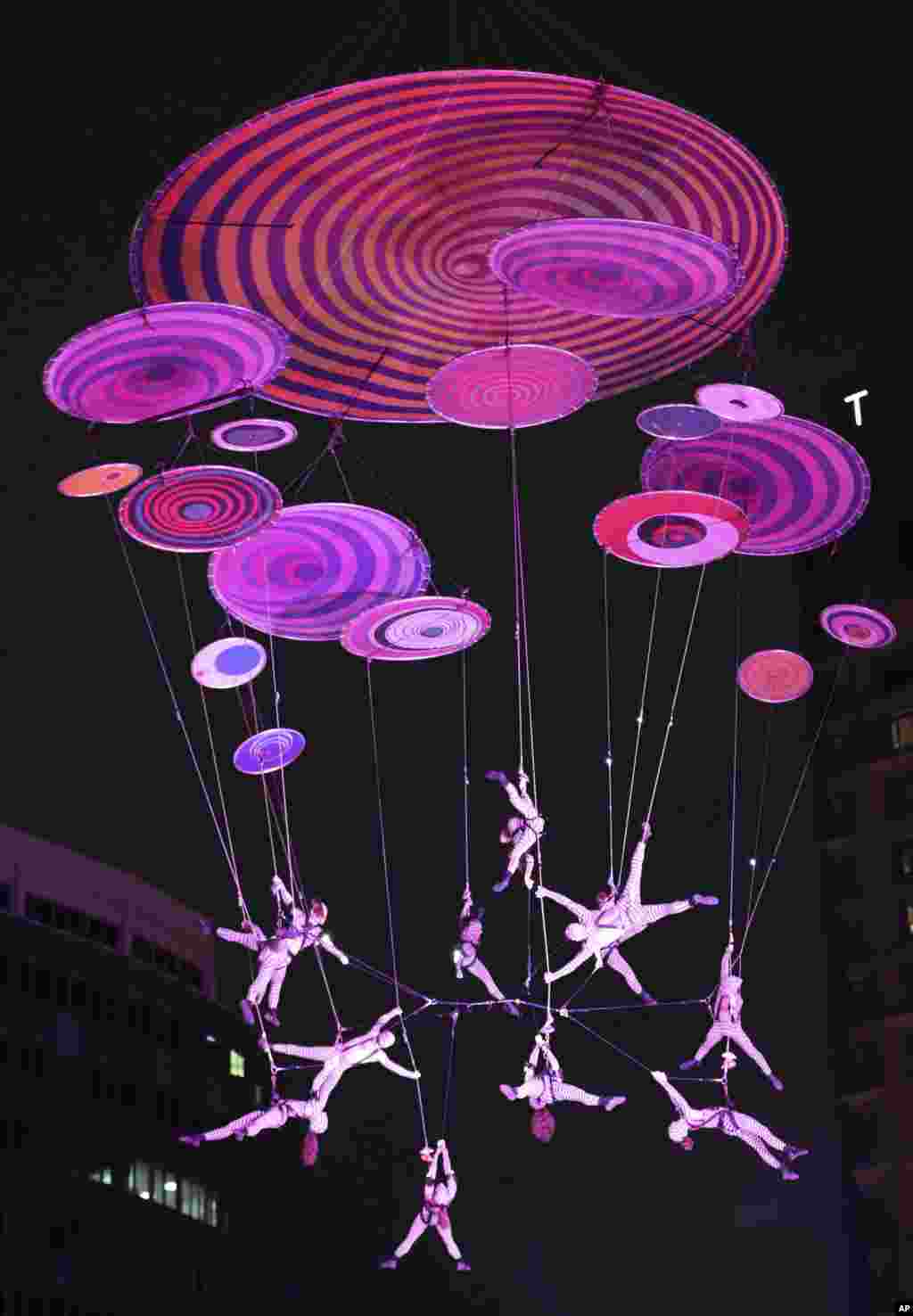 Performers of the Voala hanging from an aerial sculpture, perform the Muare Experience during the Seoul Street Arts Festival in Seoul, South Korea.