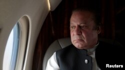 FILE - Pakistani Prime Minister Nawaz Sharif looks out the window of his plane after attending a ceremony to inaugurate the M9 motorway between Karachi and Hyderabad, Pakistan. Prime Minister Nawaz met Monday with Saudi King Shah Salman bin Abdul Aziz in Jeddah, but no progress was reported in resolving the crisis.