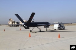 FILE - The first drone to be used by the Iraqi Air Force, loaded with ordnance, prepares to take-off to raid Islamic State group positions at an airbase in Kut, 160 kilometers southeast of Baghdad, Iraq, Oct 10, 2015.