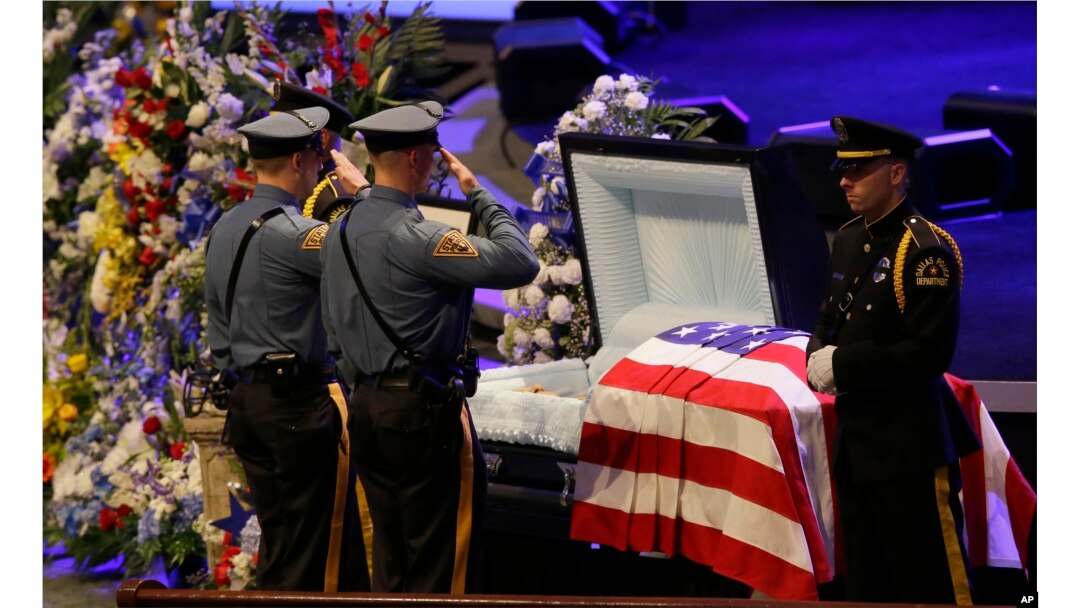 FILE - Law enforcement officer salute Dallas Police Sr. Cpl. Lorne Ahrens before his funeral service at Prestonwood Baptist Church in Plano, Texas, July 13, 2016.