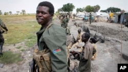 FILE - South Sudanese government soldiers stand in trenches in Malakal, South Sudan. 