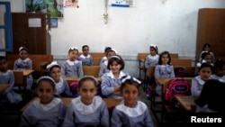 Palestinian schoolgirls sit inside a classroom at an UNRWA-run school, on the first day of a new school year, in Gaza City, Aug. 29, 2018.