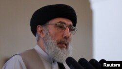 FILE - Afghan warlord Gulbuddin Hekmatyar speaks during a welcoming ceremony at the presidential palace in Kabul, Afghanistan, May 4, 2017. 