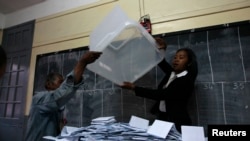 Electoral officials empty ballot box before counting votes at polling center, Antananarivo, Oct. 25, 2013.