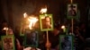 FILE - Journalists and demonstrators hold up pictures of slain journalist Javier Valdez at the Interior Ministry building in Mexico City, Mexico, May 16, 2017. 