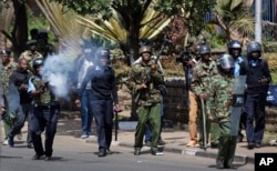 Kenyan riot police fire tear gas at opposition protesters during a rally near electoral commission offices in downtown Nairobi, Kenya, Sept. 26, 2017.