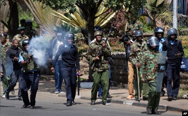 Kenyan riot police fire tear gas at opposition protesters during a rally near electoral commission offices in downtown Nairobi, Kenya, Sept. 26, 2017.