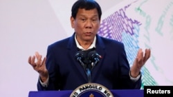 FILE - Philippines' President Rodrigo Duterte gestures during a news conference at the Association of South East Asian Nations (ASEAN) summit in Pasay, metro Manila, Philippines, Nov. 14, 2017.