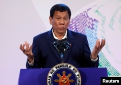 FILE - Philippines' President Rodrigo Duterte gestures during a news conference at the Association of South East Asian Nations (ASEAN) summit in Pasay, metro Manila, Philippines, Nov. 14, 2017.