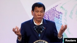 FILE - Philippines' President Rodrigo Duterte gestures during a news conference in Pasay, metro Manila, Nov. 14, 2017.