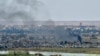 FILE - Smoke rises from the Islamic State (IS) group's last remaining position in the village of Baghuz during battles with the Syrian Democratic Forces (SDF), in the countryside of the eastern Syrian province of Deir el-Zour, March 20, 2019.