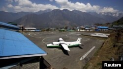 FILE - A Twin Otter aircraft belonging to Tara Air is pictured at Tenzing Hillary Airport, in Lukla, approximately 2800 meters above sea level, in Solukhumbu district, Nepal. The missing plane was flying from Pokhara, a major tourist center located about 200 kilometers west of Kathmandu, to Jomsom, a popular spot for hikers.