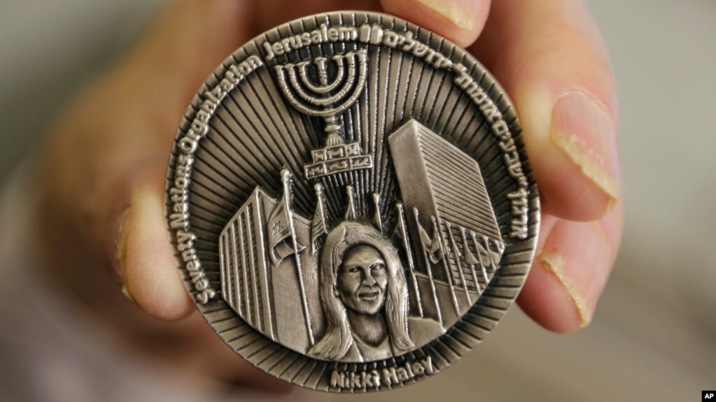 This March 13, 2019, photo shows a coin emblazoned with the face of Nikki Haley, President Donald Trump's former ambassador to the United Nations, to commemorate her defense of Israel in the United Nations, in Jerusalem.