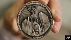 This March 13, 2019, photo shows a coin emblazoned with the face of Nikki Haley, President Donald Trump's former ambassador to the United Nations, to commemorate her defense of Israel in the United Nations, in Jerusalem.