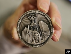 This March 13, 2019, photo shows a coin emblazoned with the face of Nikki Haley, President Donald Trump's former ambassador to the United Nations, to commemorate her defense of Israel in the United Nations, in Jerusalem.