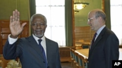 Newly appointed UN-Arab League Envoy on Syria Kofi Annan waves to the media after shaking hand with France's Foreign Minister Alain Juppe, before the19th session of the Human Rights Council at the United Nations, in Geneva, February 27, 2012.