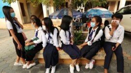 Students wearing face-masks, wait for their morning school class at Santhormok high school, in Phnom Penh, Cambodia, Monday, Nov. 2, 2020. (AP Photo/Heng Sinith)