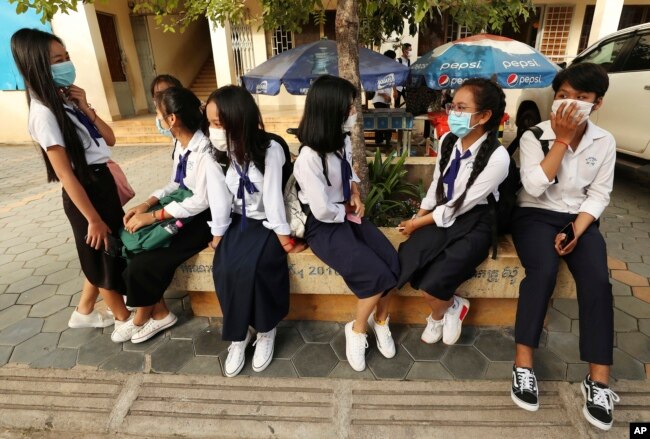 Students wearing face-masks, wait for their morning school class at Santhormok high school, in Phnom Penh, Cambodia, Monday, Nov. 2, 2020. (AP Photo/Heng Sinith)