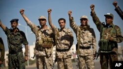 Houthi Shiite Yemenis wearing army uniforms chant slogans during a rally to show support for their comrades in Sanaa, Yemen, Feb. 4, 2015.