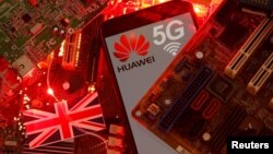 FILE - The British flag and a smartphone with a Huawei and 5G network logo are seen on a PC motherboard in this illustration picture taken January 29, 2020.