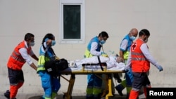 Health workers push a stretcher with a patient in the emergency unit at 12 de Octubre hospital amid the coronavirus disease (COVID-19) pandemic, in Madrid, Spain, Sept. 2, 2020.