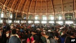 FILE - Undocumented immigrants fill out application forms for the Obama administration's Deferred Action for Childhood Arrivals (DACA) program at Navy Pier in Chicago, Aug. 15, 2012.