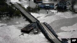 A barge damages a bridge that divides Lafitte, La., and Jean Lafitte, in the aftermath of Hurricane Ida, Aug. 30, 2021, in Lafitte, La.