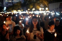 FILE - Thousands of people take part in a candlelight vigil to mark the 30th anniversary of the crackdown of pro-democracy movement at Beijing's Tiananmen Square in 1989, at Victoria Park in Hong Kong, June 4, 2019.