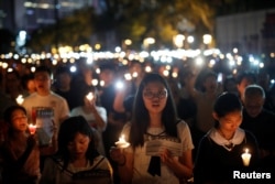 FILE - Thousands of people take part in a candlelight vigil to mark the 30th anniversary of the crackdown of pro-democracy movement at Beijing's Tiananmen Square in 1989, at Victoria Park in Hong Kong, June 4, 2019.
