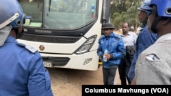 Opposition leader Jameson Timba (in blue jacket and black hat) is shown after his arrest in Harare, Zimbabwe in June 2024 