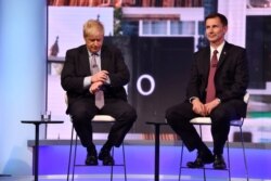 FILE - Boris Johnson and Jeremy Hunt appear on BBC TV's debate with candidates vying to replace British PM Theresa May, in London, Britain, June 18, 2019.