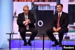 FILE - Boris Johnson and Jeremy Hunt appear on BBC TV's debate with candidates vying to replace British PM Theresa May, in London, Britain, June 18, 2019.