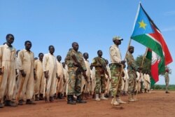 Trainees parade during the visit of the defense minister to a military training center in Owiny Ki-Bul, Eastern Equatoria, South Sudan, June 27, 2020.