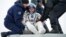 FILE - Expedition 38 Flight Engineer Sergei Ryazanskiy of the Russian Federal Space Agency, Roscosmos, is helped out of a Soyuz Capsule near the town of Zhezkazgan, Kazakhstan, in a March 11, 2014, photo. 