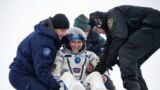 Expedition 38 Flight Engineer Mike Hopkins of NASA gives a thumbs up as he is helped from the Soyuz Capsule just minutes after he, Commander Oleg Kotov of the Russian Federal Space Agency and Flight Engineer Sergey Ryazanskiy of Roscosmos, landed in their Soyuz TMA-10M spacecraft near the town of Zhezkazgan, Kazakhstan.