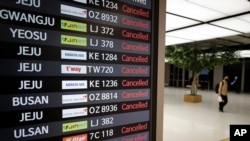 An electronic signboard shows canceled flights at the Gimpo Airport in Seoul, South Korea, Sept. 2, 2020.