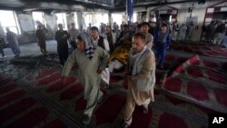 Men carry the coffin of a victim of a suicide attack at a Shiite mosque, Aug. 26, 2017, in Kabul, Afghanistan.