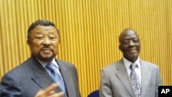 AU Commission Chairman Jean Ping (l) and the acting Peace and Security Council Chairman, Nigerian Ambassador B. Paul Lolo brief reporters at African Union HQ, March 23, 2012