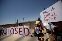 Activists hold a protest against the treatment and conditions of children in immigration detention outside U.S. Customs and Border Protection's Border Patrol station facilities in Clint, Texas, June 27, 2019.