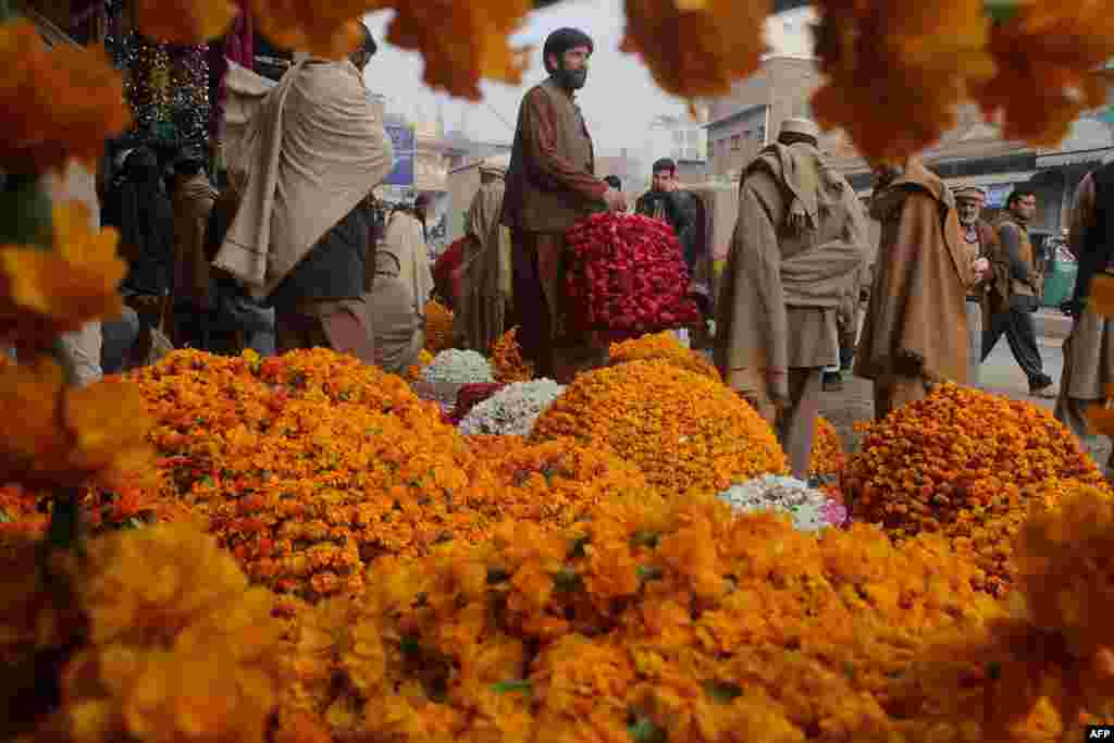 Pakistani vendors sell garlands at a flower market in Peshawar, Pakistan.