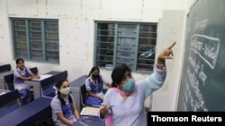 A teacher gives a lesson inside a classroom, in New Delhi, Sep 1, 2021.