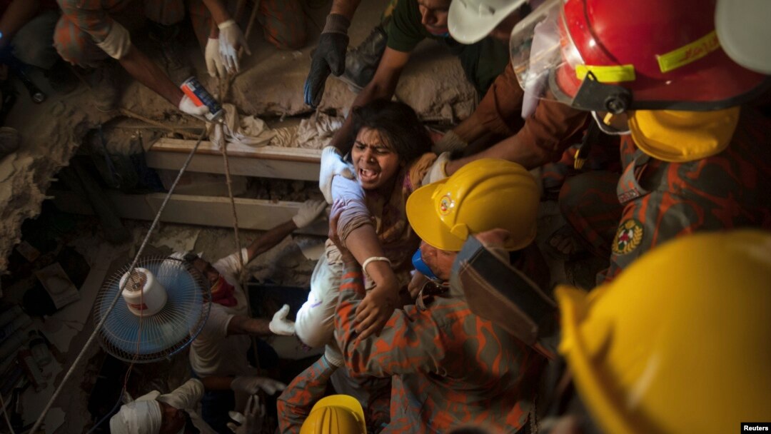 FILE - Rescue workers rescue a garment worker from the rubble of the collapsed Rana Plaza building, in Savar, 30 km (19 miles) outside Dhaka, Bangladesh, April 27, 2013. 