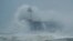 Waves crash over the harbor and a lighthouse, as Storm Ciara hits Newhaven, on the south coast of England, Feb. 9, 2020. 